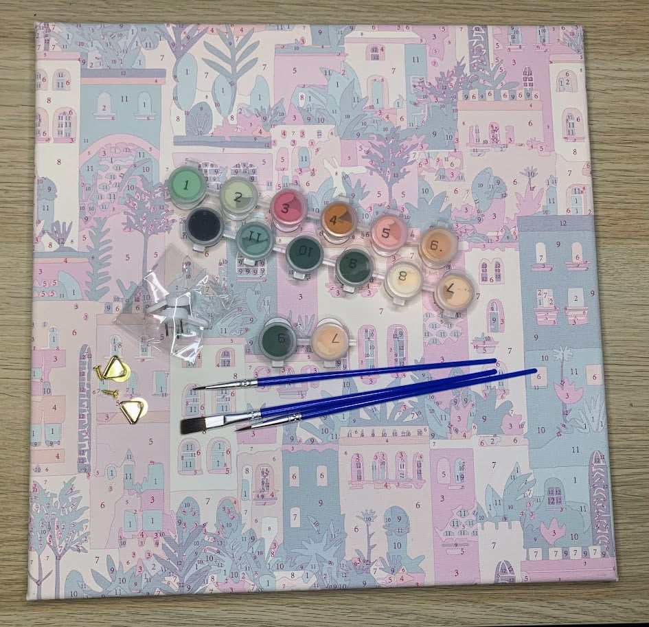 A paint by numbers kit with paints, brushes, canvas and fixings