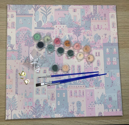 A paint by numbers kit with paints, brushes, canvas and fixings
