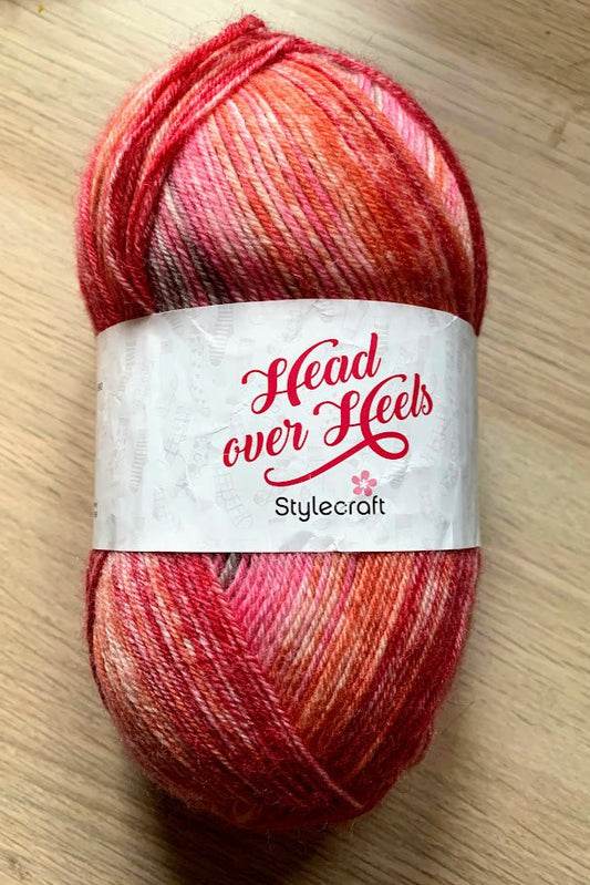 Sock yarn with stripes of pink and red knitted on 2.5mm needles